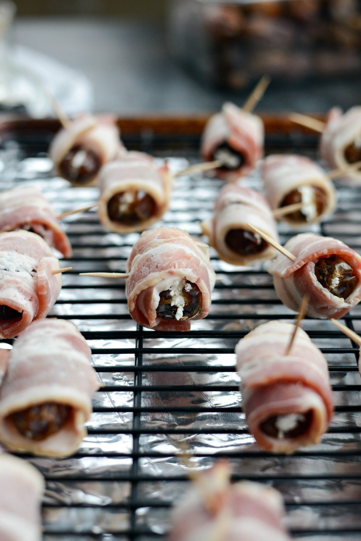 Wrap with half a slice of bacon and place on wire rack set over rimmed baking sheet.