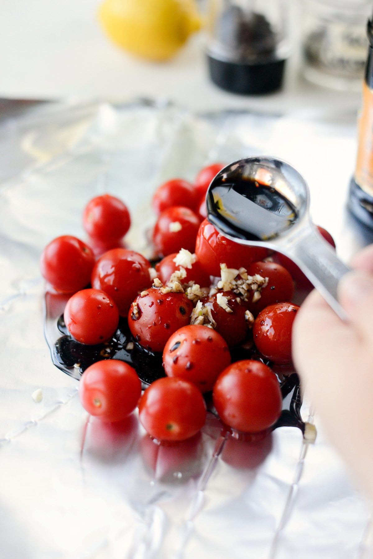 making tomato foil pack with tomatoes, garlic and balsamic vinegar