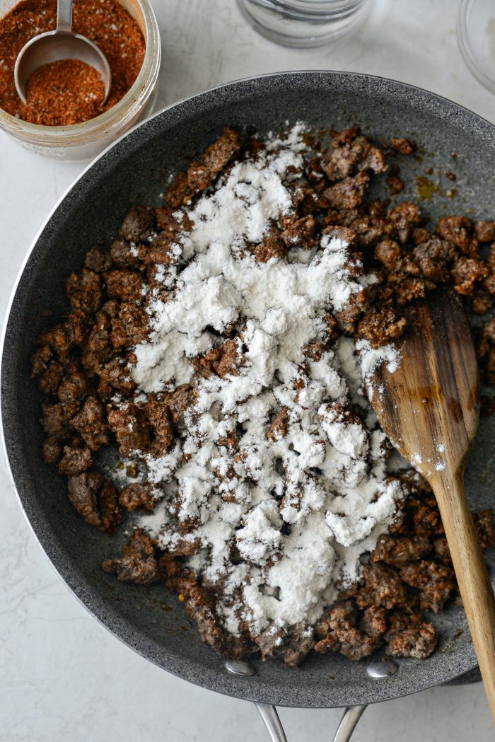 flour sprinkled over seasoned taco meat