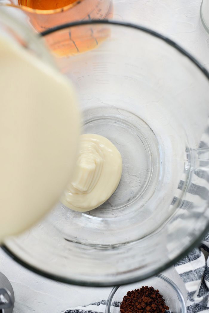 pouring sweetened condensed milk in a bowl