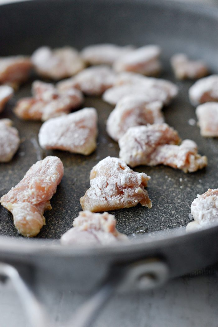 add coated chicken to pan with oil