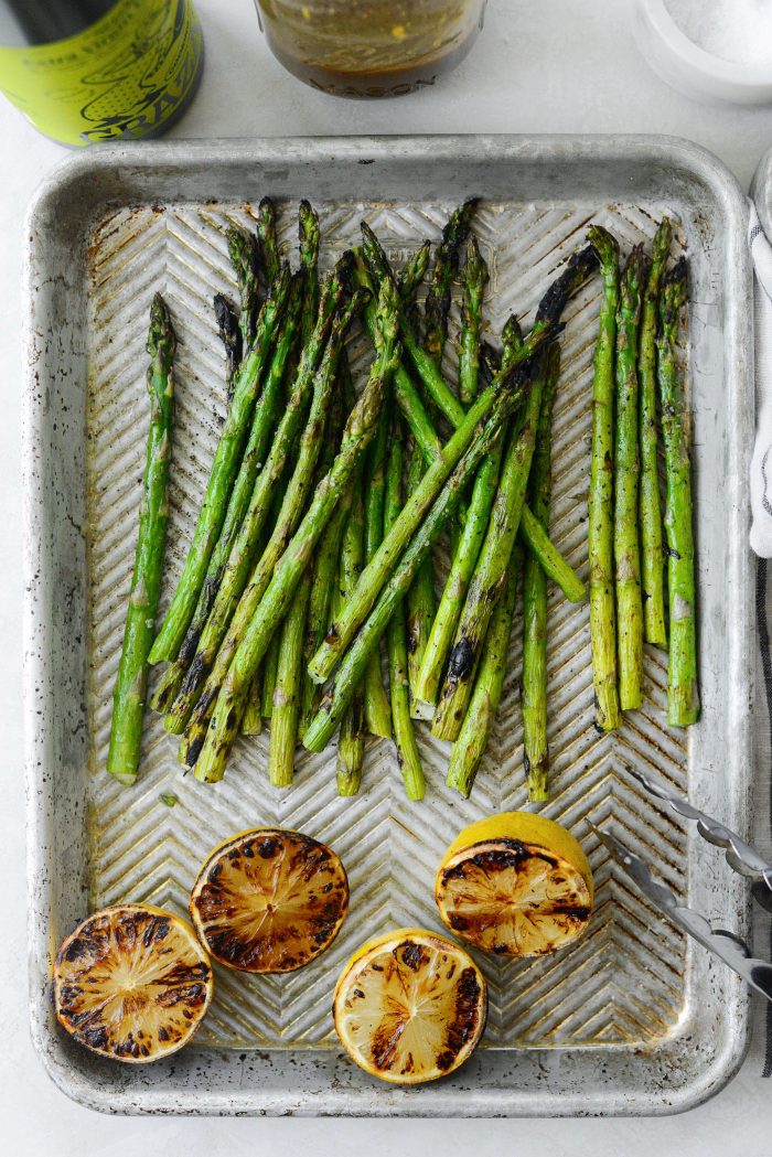 Transfer grilled asparagus and lemons to pan