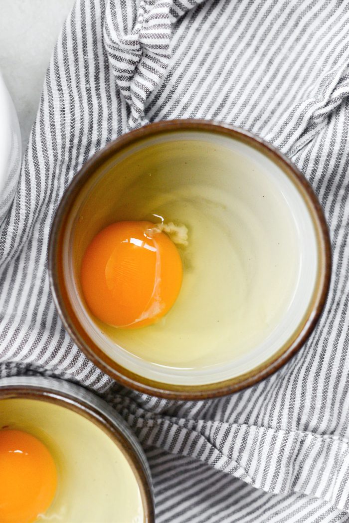 crack eggs into shallow bowls