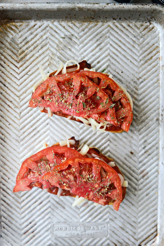 top with tomato, black pepper and Italian seasoning