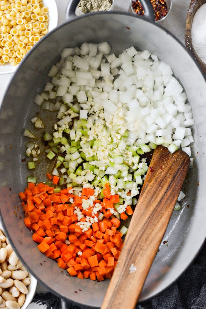 remove sausage and add in veggies and garlic with salt