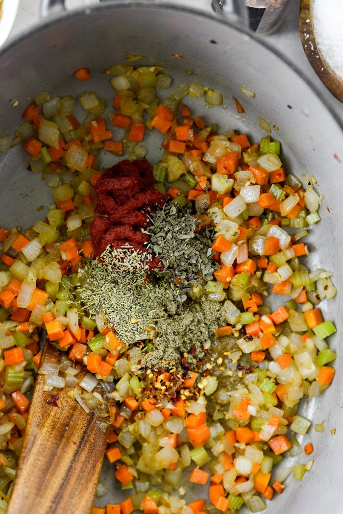 add tomato paste, herbs and red pepper flakes