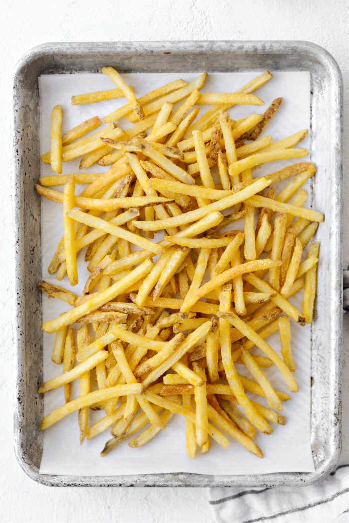 add French fries to 2 rimmed quarter baking sheet pans