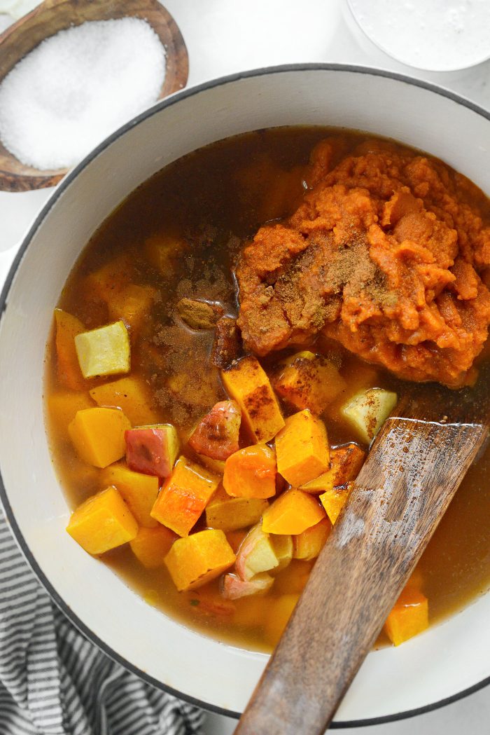 add pumpkin, apples, butternut squash, maple syrup, spices and broth to pot