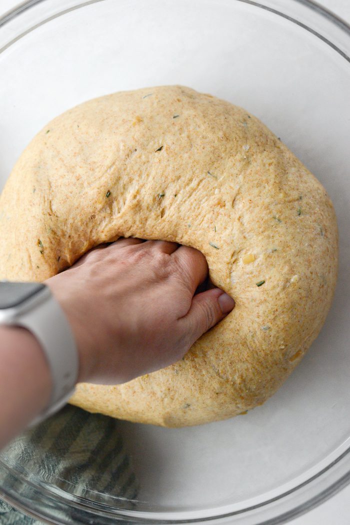 deflate dough by punching/pressing out the air