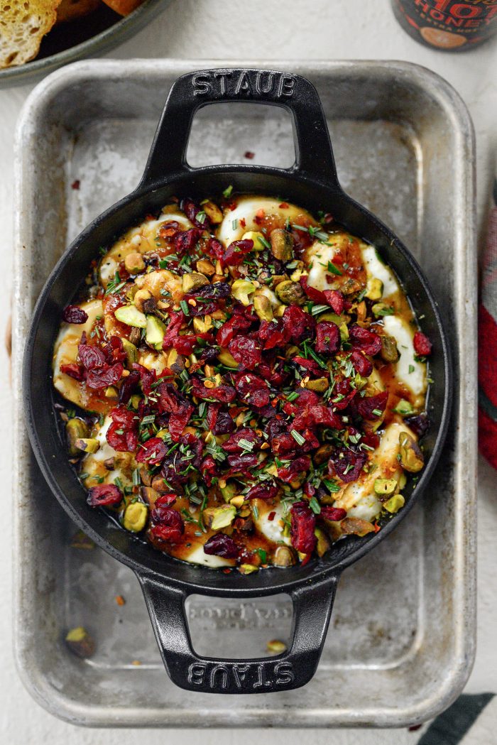 Top with black pepper, chopped pistachios and cranberries, rosemary