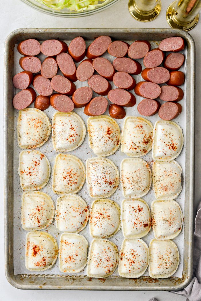 arrange kielbasa and pierogis on pan